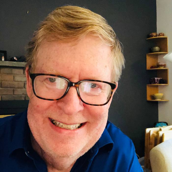 Photo of Bill Abramovitz with dark blue shirt and reddish hair